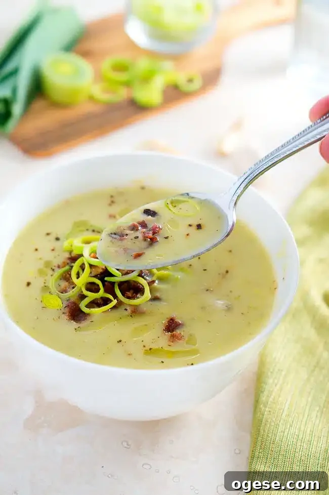 Creamy Potato and Leek Soup being eaten with a spoon
