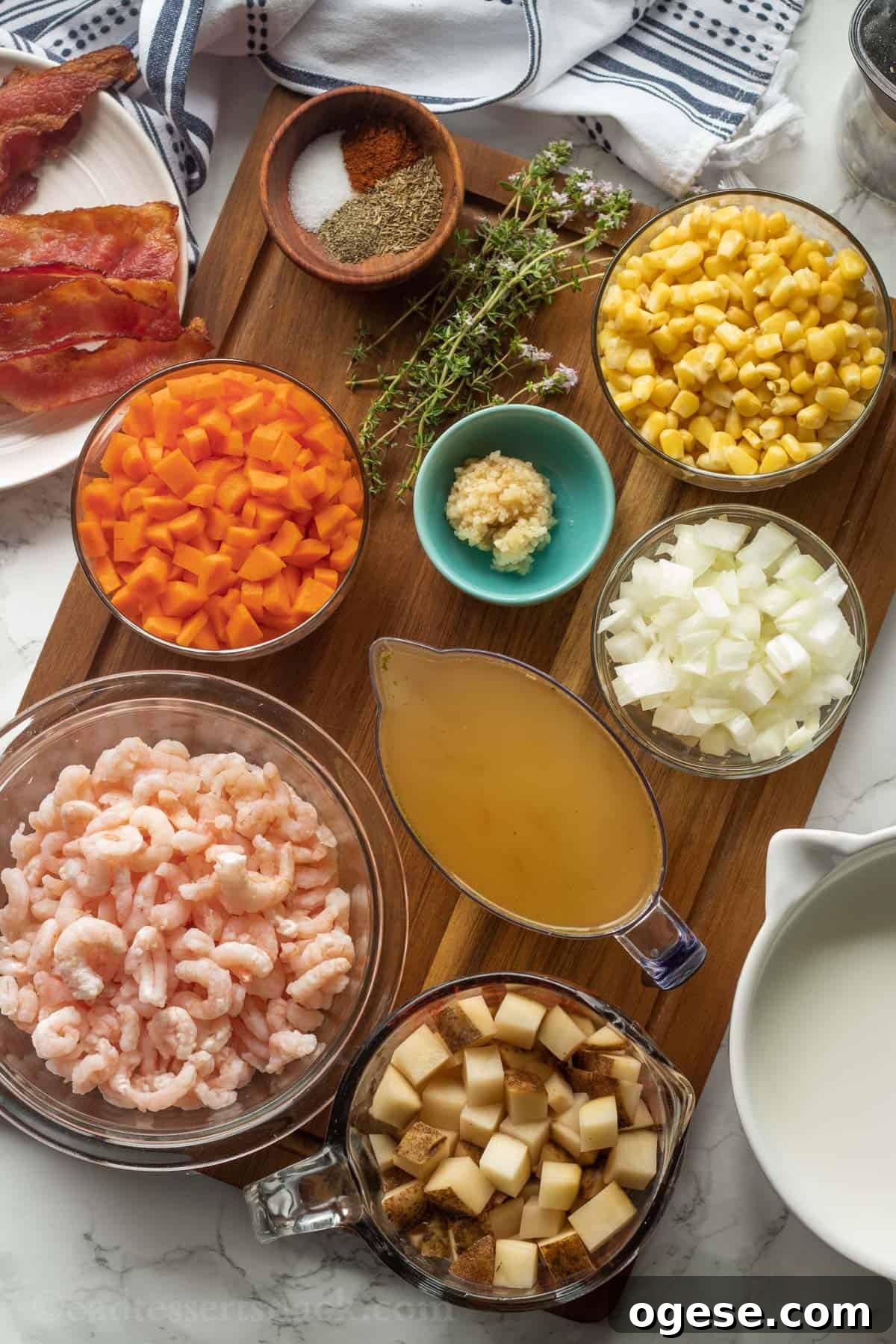 Ingredients for Shrimp Corn Chowder in bowls on wood cutting board.