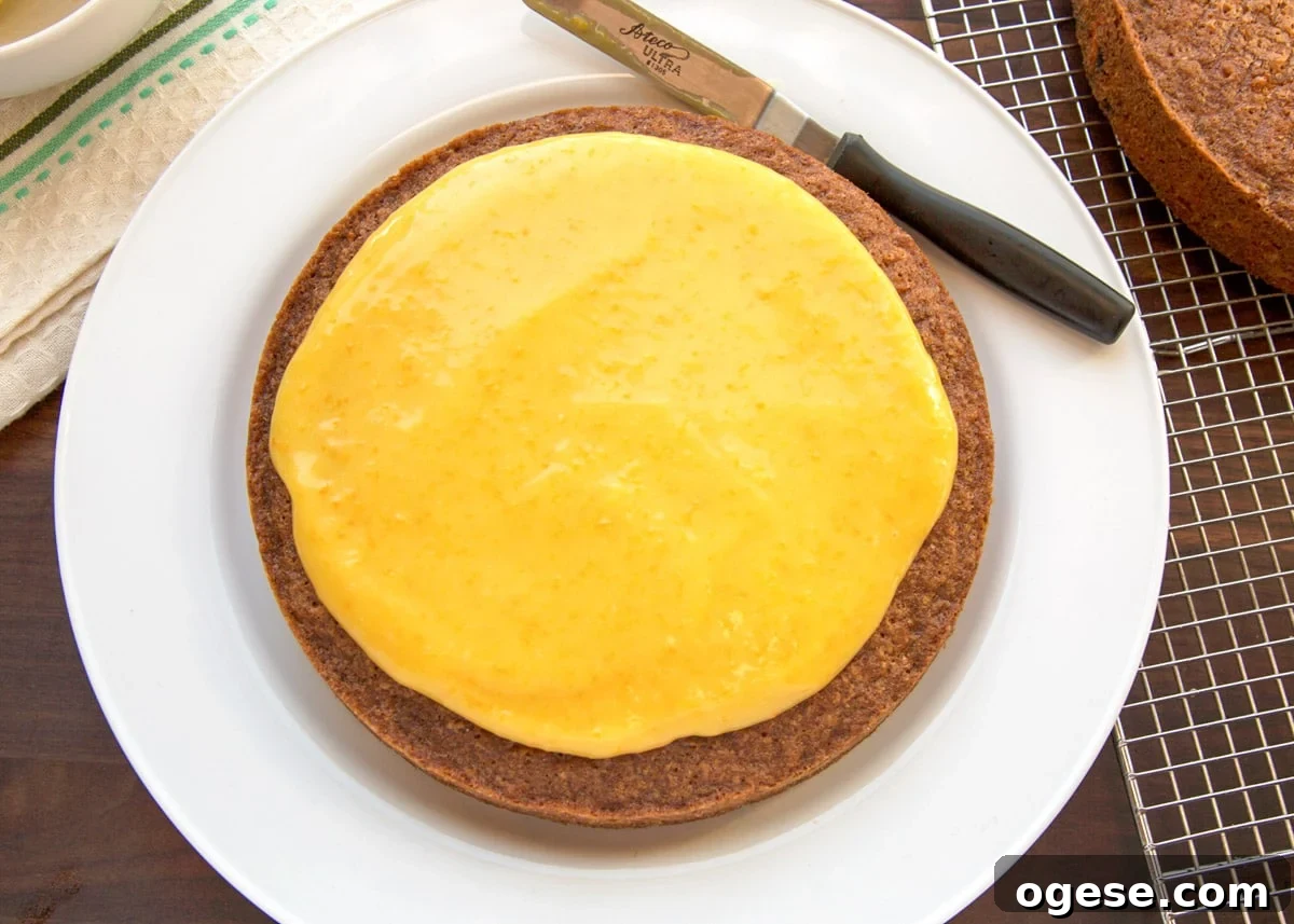 base layer of carrot cake spread with orange curd filling