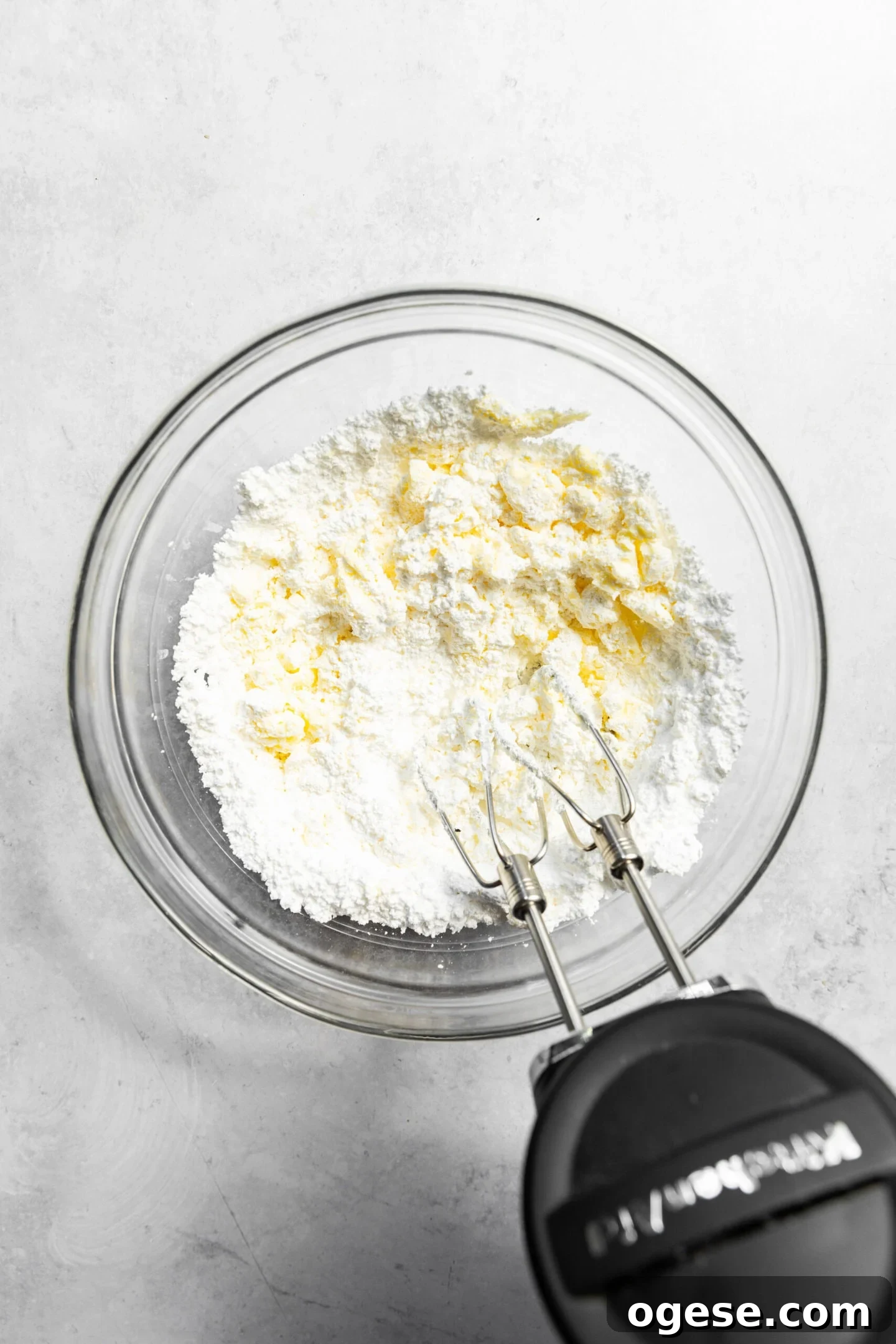 Butter and powdered sugar being beaten together.