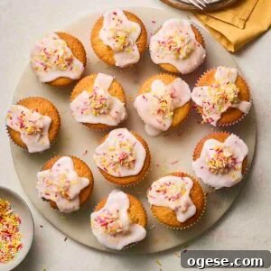A plateful of iced fairy cakes.