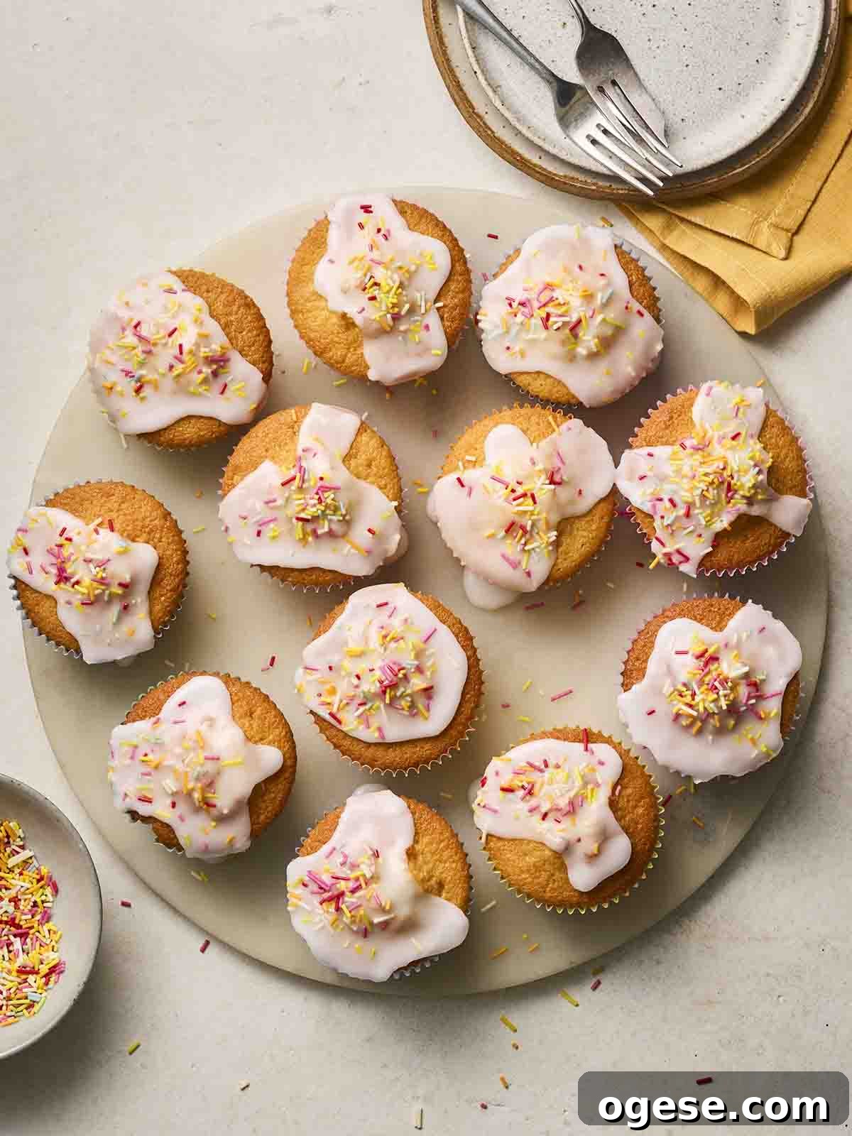 A plate of iced fairy cakes, ready to eat.