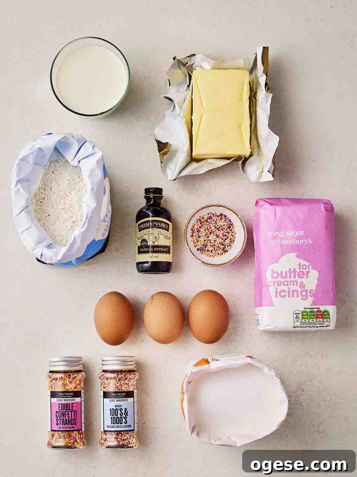 The ingredients for making Fairy Cakes laid out on a white counter.