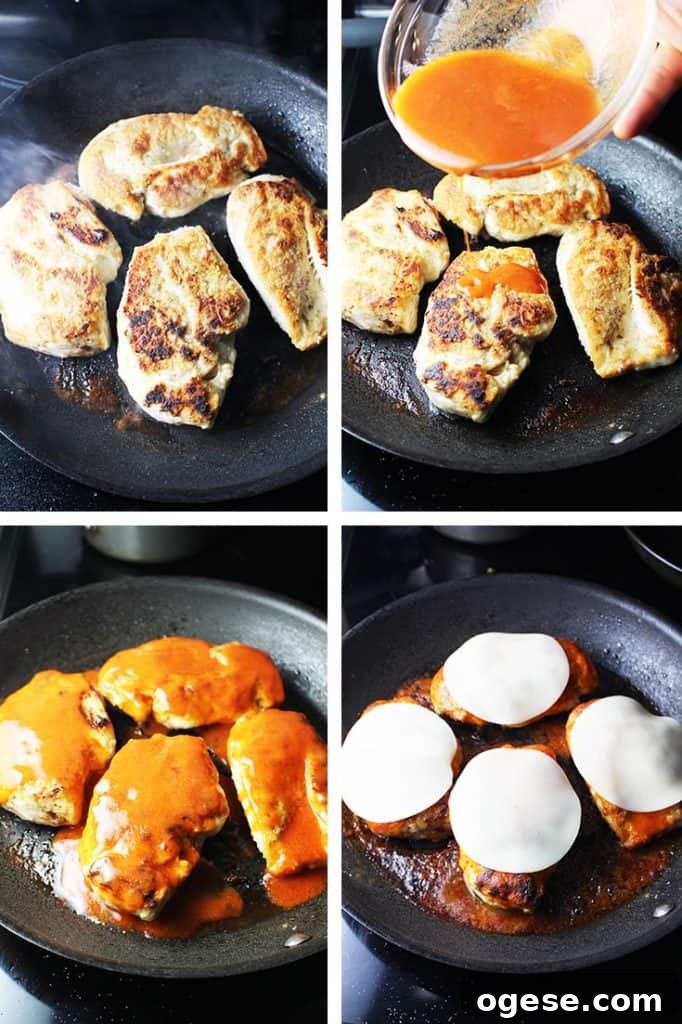 Chicken breasts being pan fried and smothered in Buffalo wing sauce and cheese for Buffalo chicken breast burgers