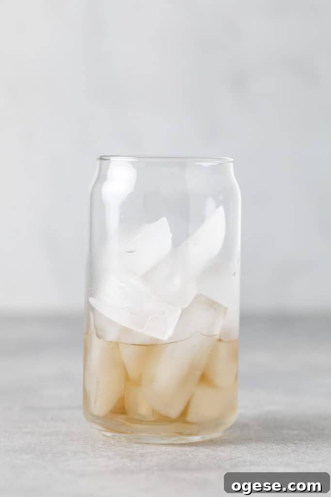 Iced Blonde Vanilla Latte Recipe: Creamy Cold Coffee Guide 3 Vanilla syrup poured into a glass over ice.
