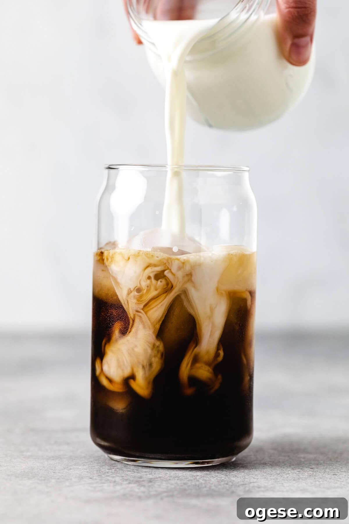 Iced Blonde Vanilla Latte Recipe: Creamy Cold Coffee Guide 4 Milk being poured into an iced latte.