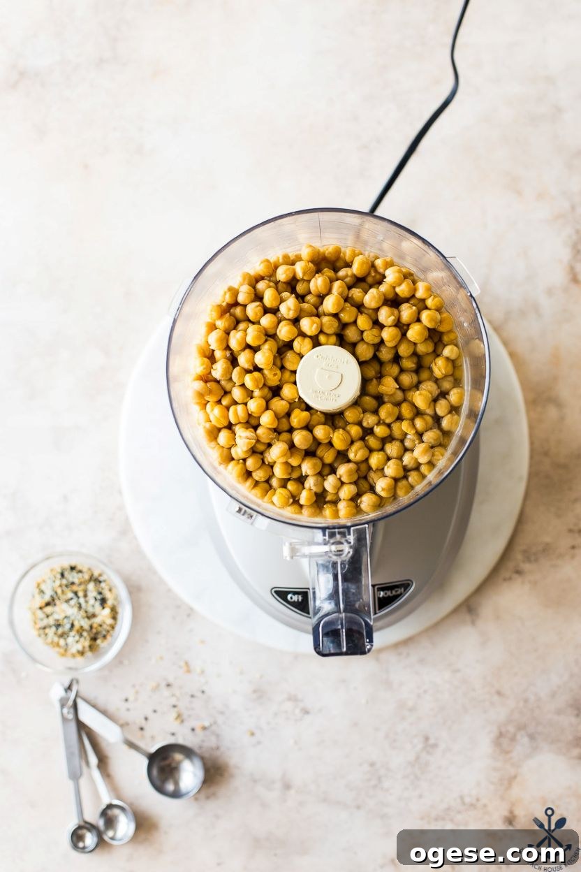 Ultimate Guide to Hummus: Recipes, Tips, and Serving Ideas 6 Overhead photo of a food processor filled with chickpeas