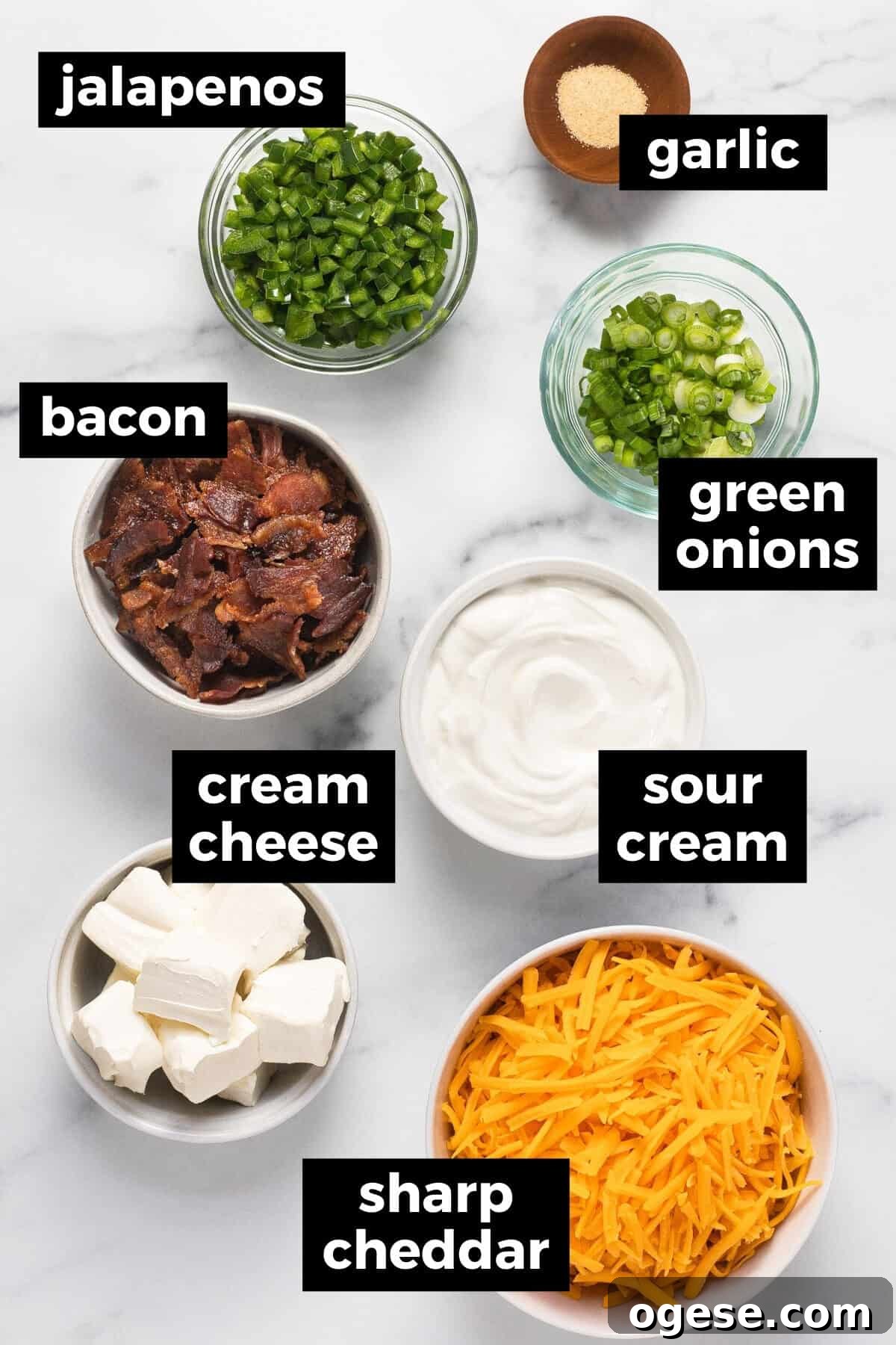 White marble counter top with ingredients to make jalapeno popper dip