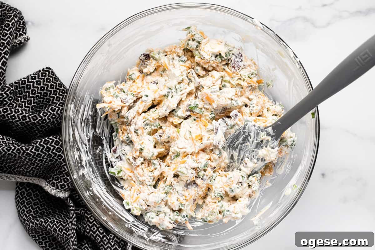Large glass bowl filled with ingredients to make jalapeno popper dip