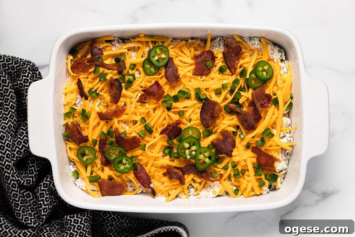 White baking dish filled with homemade jalapeno popper dip