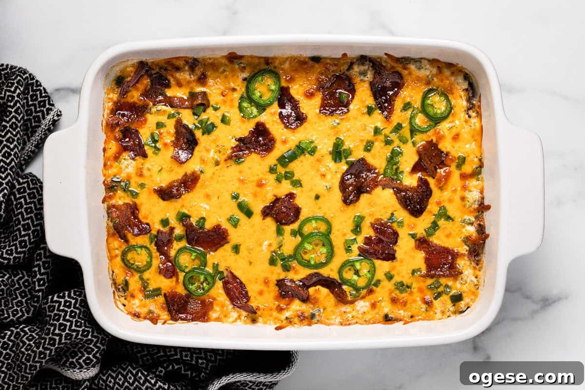 Freshly baked jalapeno popper dip in a large white baking dish