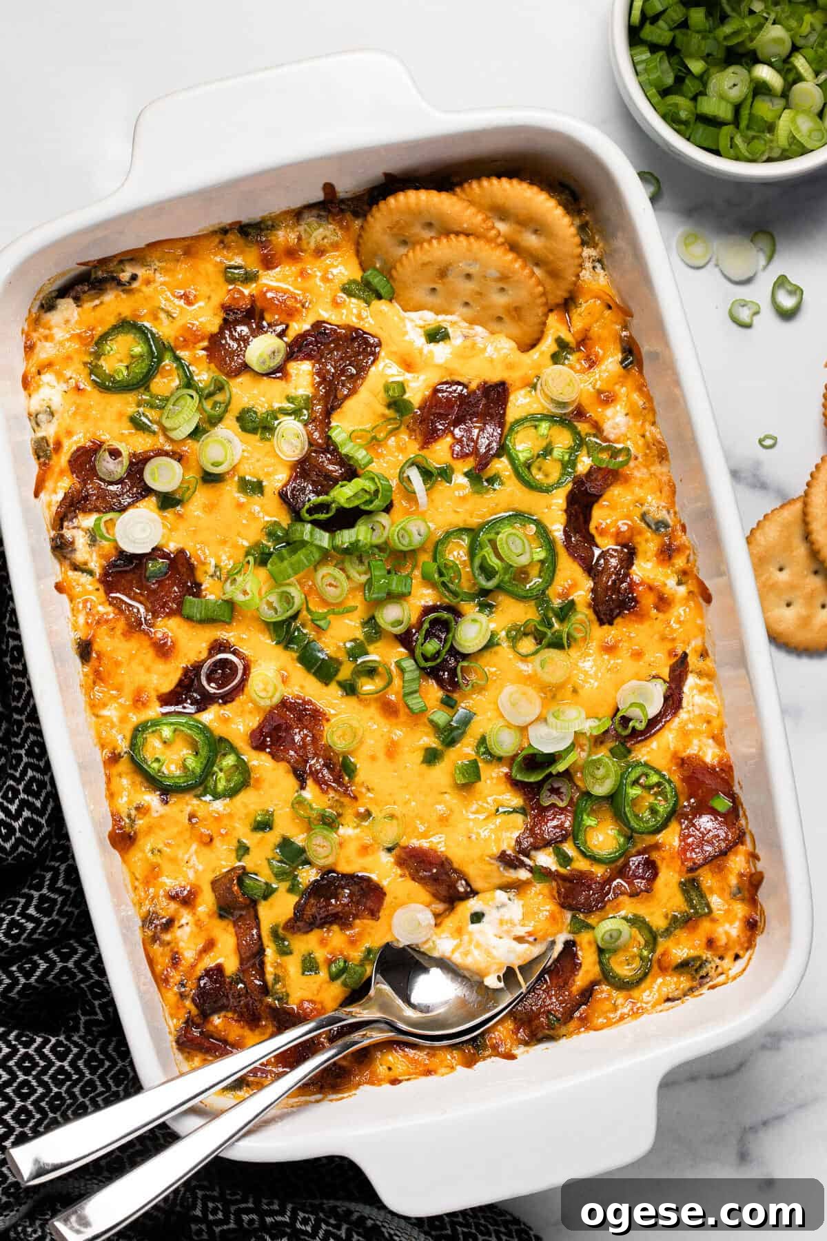 Large white baking dish filled with homemade jalapeno popper dip