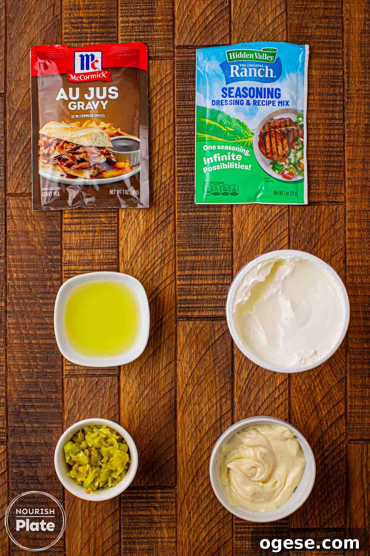 Ingredients for Mississippi Sin Dip including ranch seasoning mix, au jus gravy mix, sour cream, mayonnaise, pepperoncini peppers, and pepperoncini juice