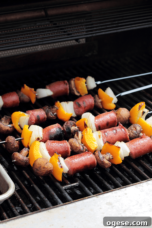sausage and veggie kabobs on skewers on a grill