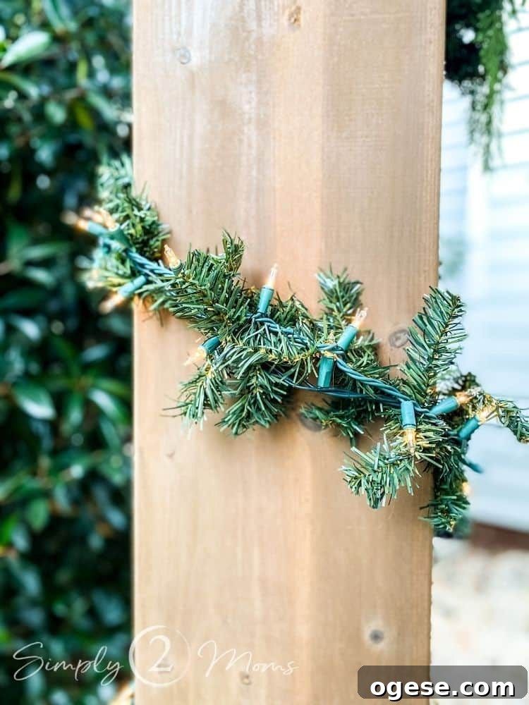 Cheap Christmas garland and lights wrapped around a post