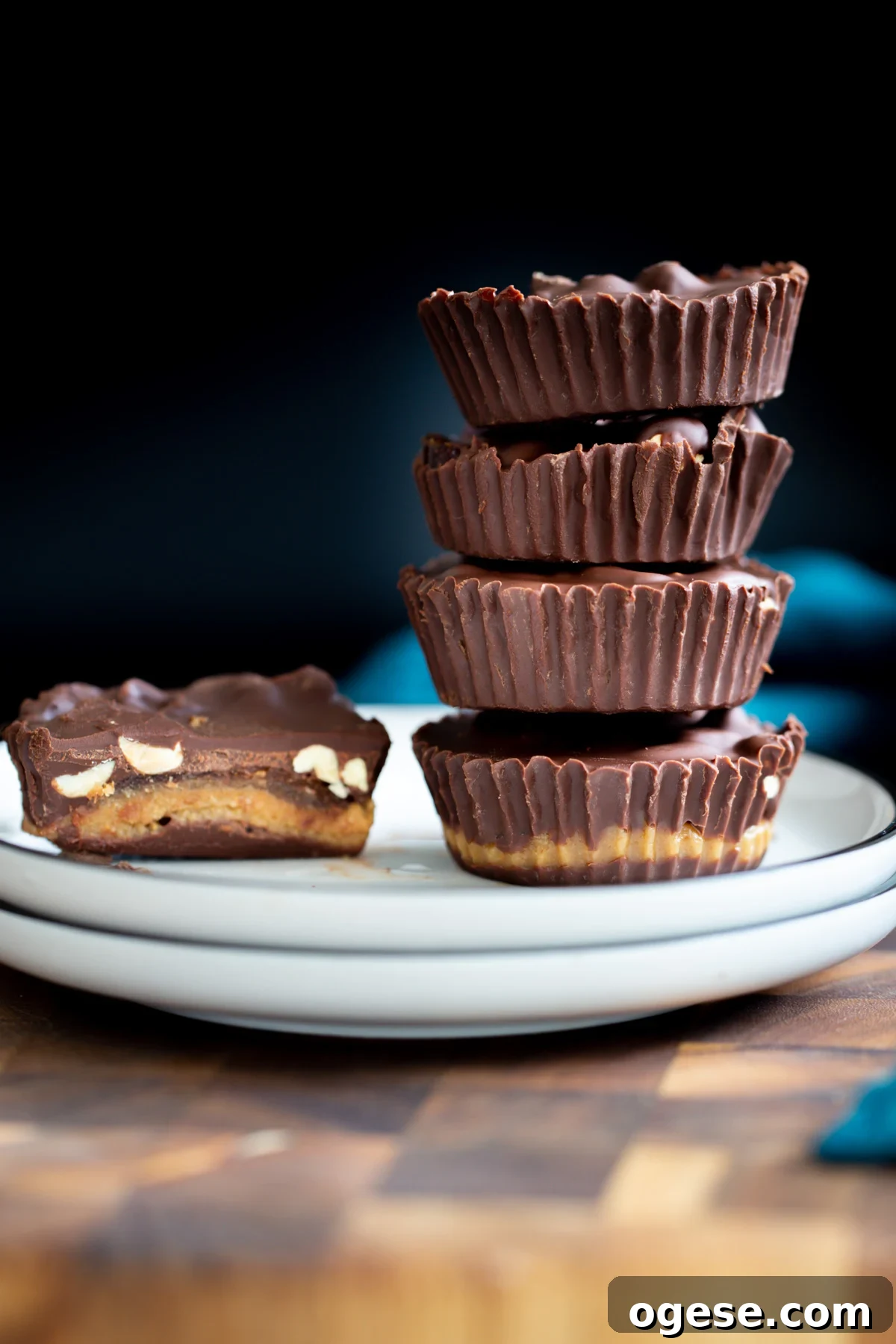 vegan snickers cups vegan peanut butter snickers cups with dates against a black background