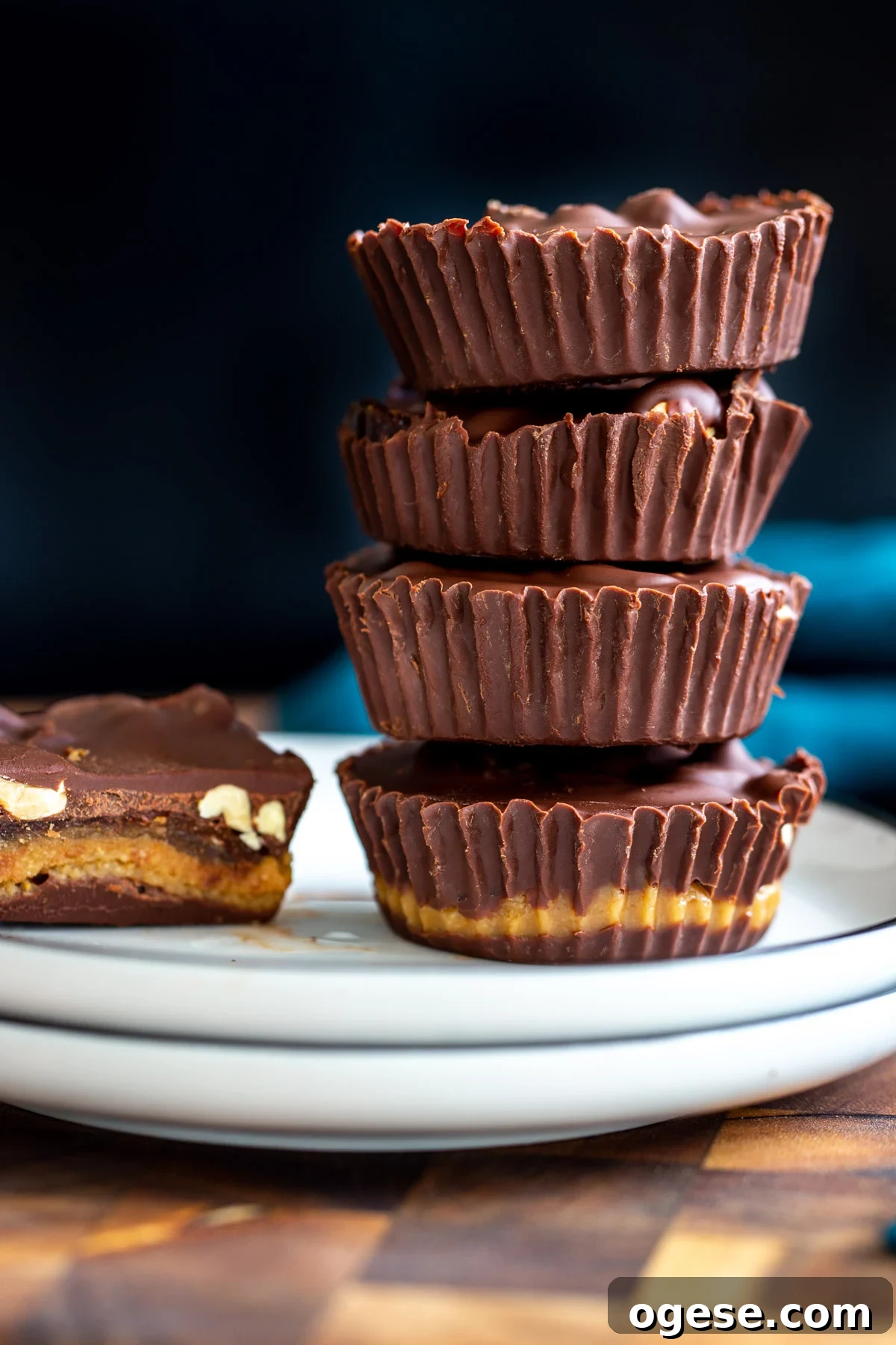 Vegan Snickers-Style Peanut Butter Cups Recipe 4 stacked vegan peanut butter cups with peanut butter nougat and dates