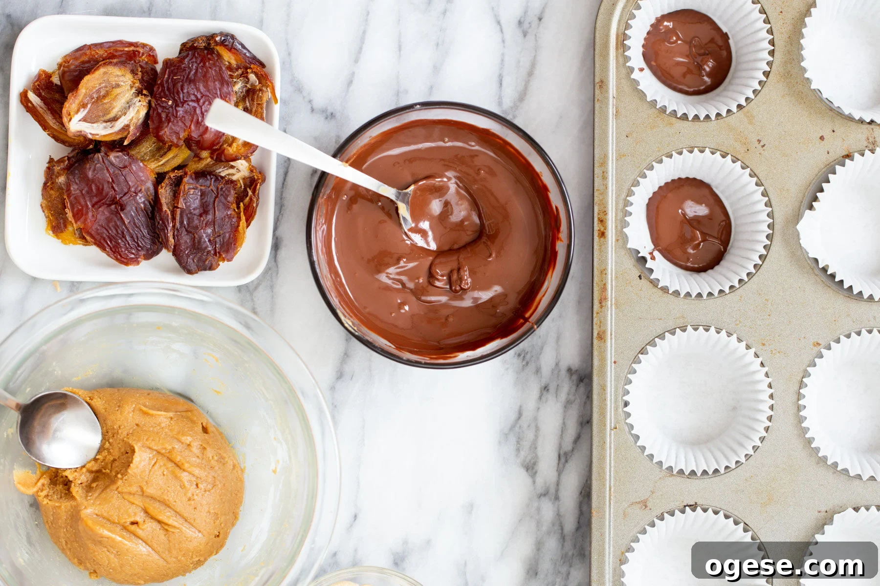 vegan snickers cups melted chocolate being spread into molds to make vegan snickers cups