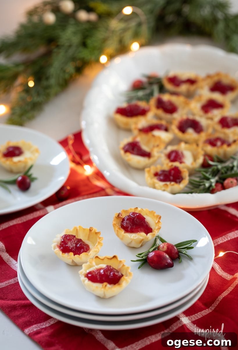Cranberry Brie Bites on a platter and plates.