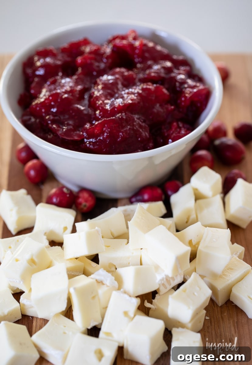 cubed brie and cranberry sauce in a bowl.