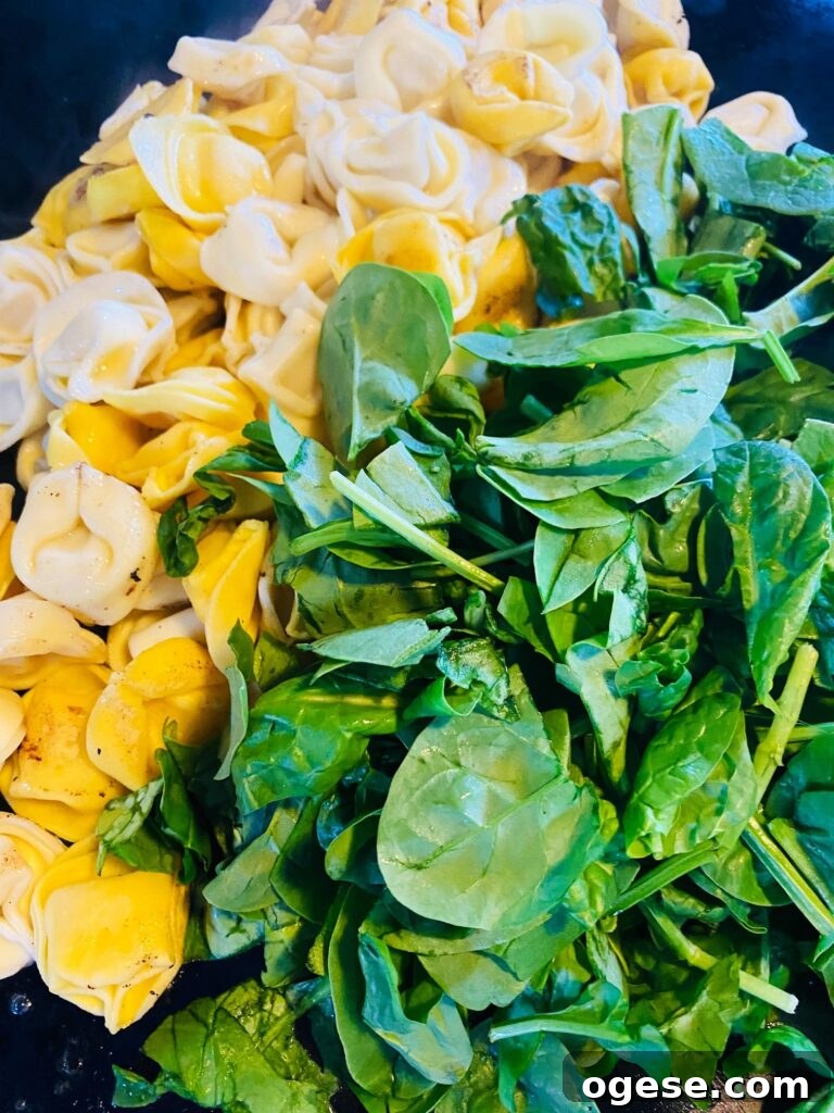 adding spinach to the griddle