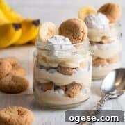 Two jars of vegan banana pudding with bananas in the background.