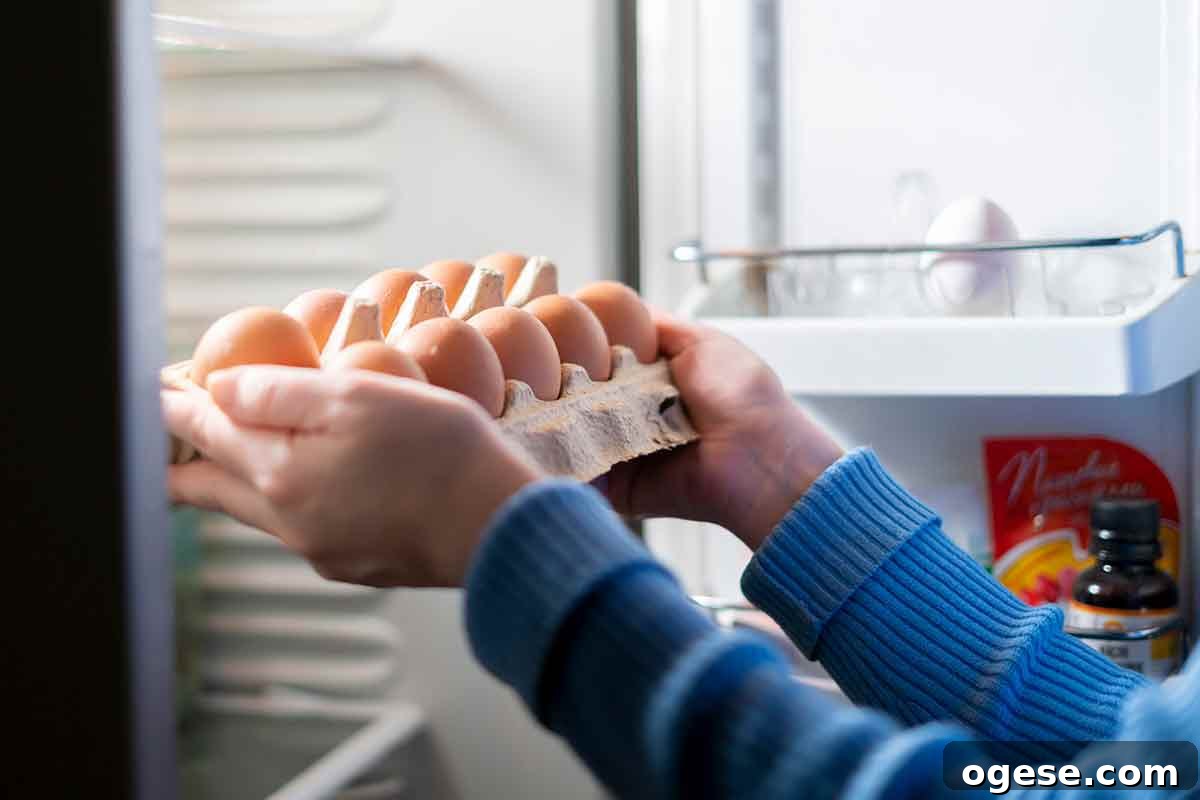 How to Cook and Use Eggs: Practical Tips and Techniques 4 A woman placing a dozen raw eggs in the refrigerator