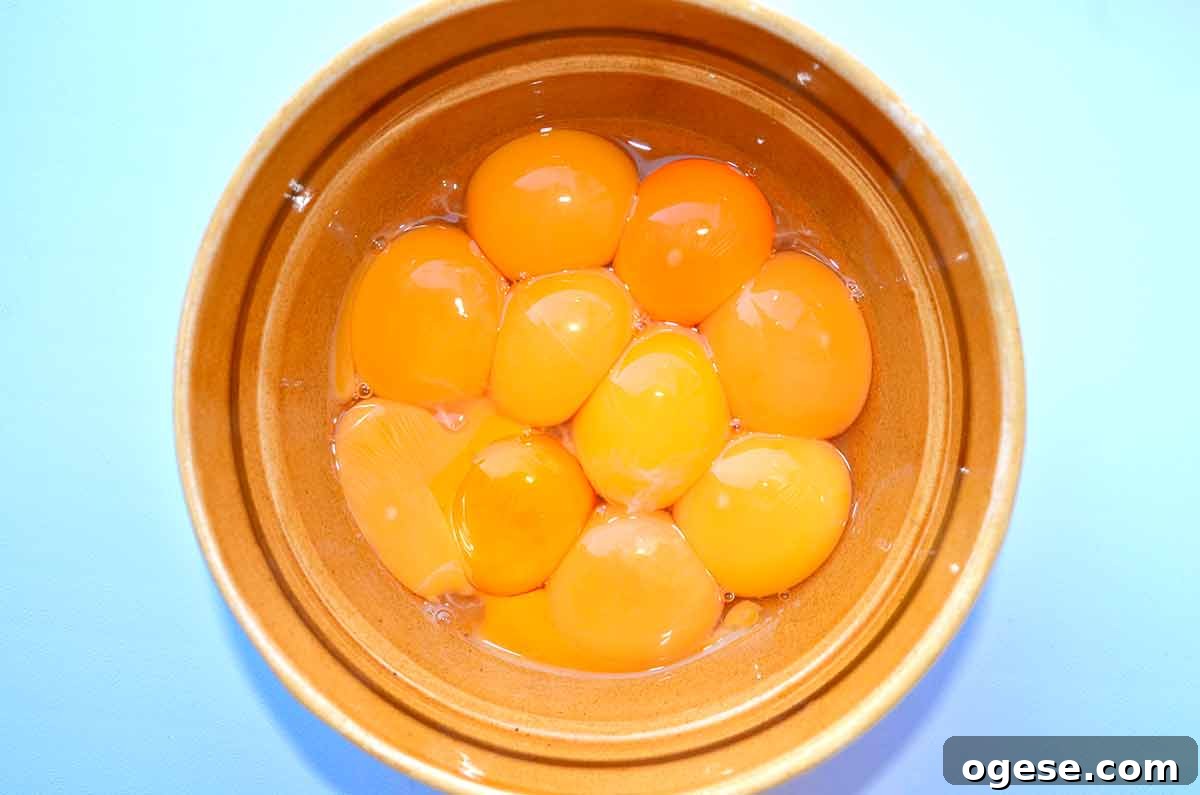 How to Cook and Use Eggs: Practical Tips and Techniques 8 A bowl of yolks that range in color from deep orange to pale yellow