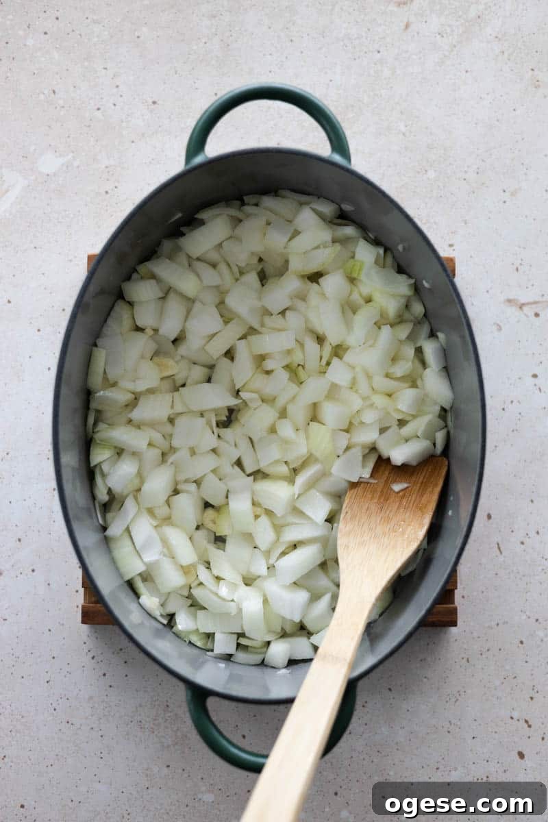 Roasted Red Pepper and Tomato Soup Recipe for Cozy Weeknights 6 Onions in a soup pot.