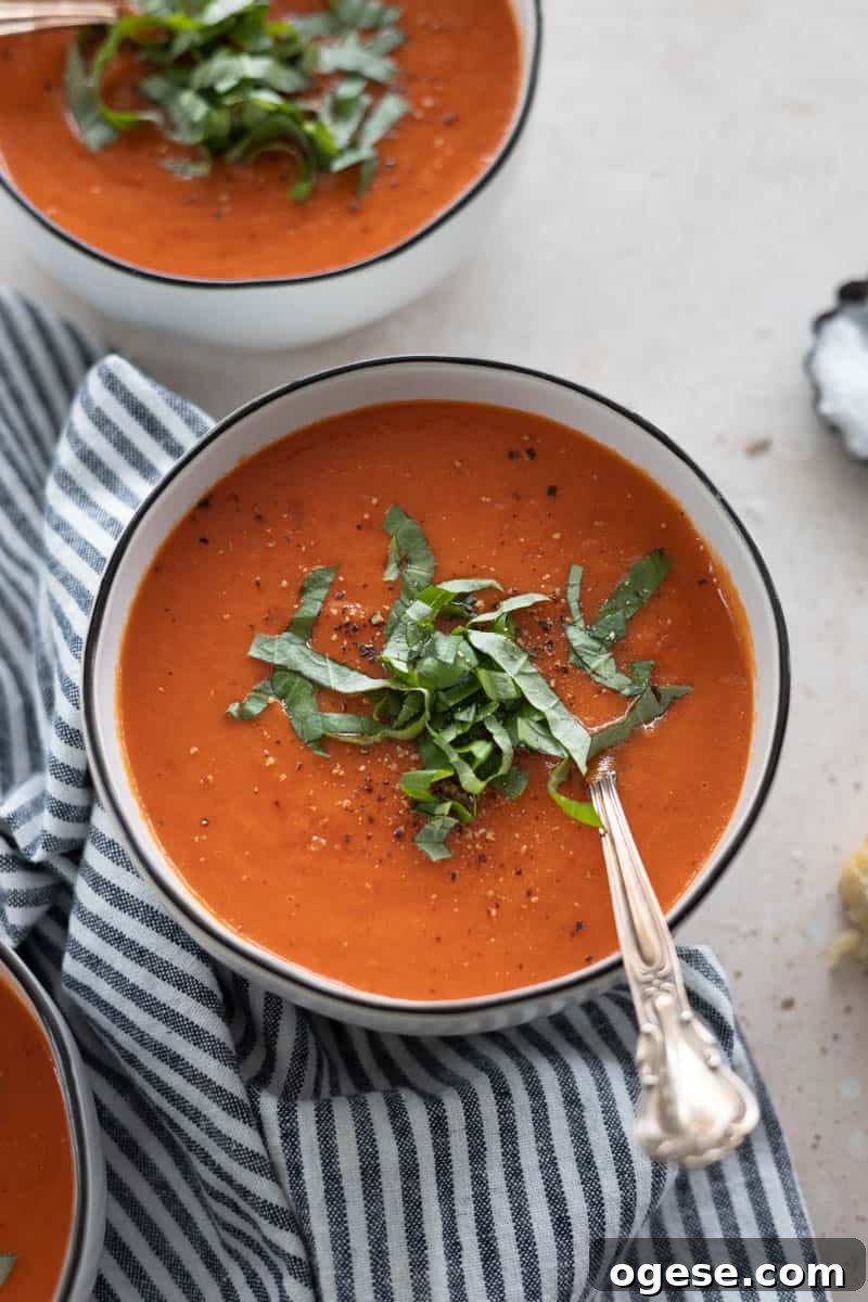 Roasted Red Pepper and Tomato Soup Recipe for Cozy Weeknights 9 Roasted Red Pepper and Tomato Soup in a bowl.