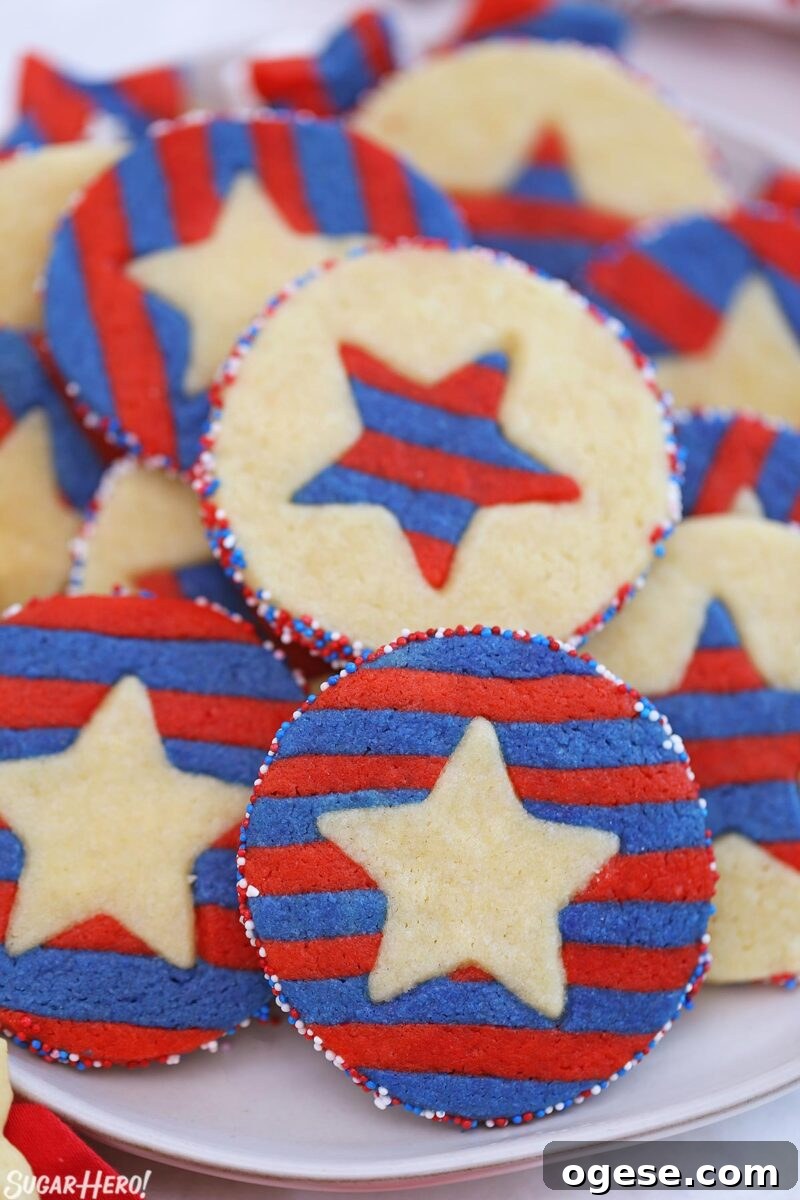 Red, white, and blue sugar cookies with striped stars embedded inside.