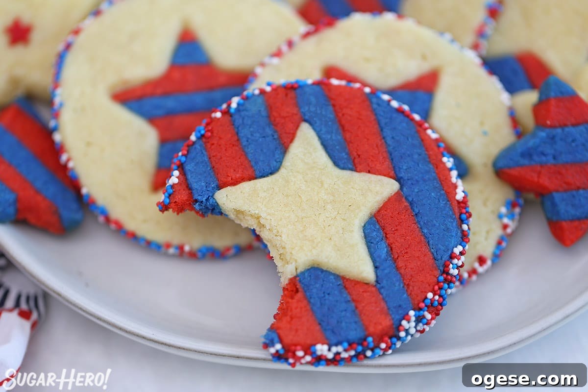 Close-up of Stars and Stripes Sugar Cookies with a bite taken out of one of them.