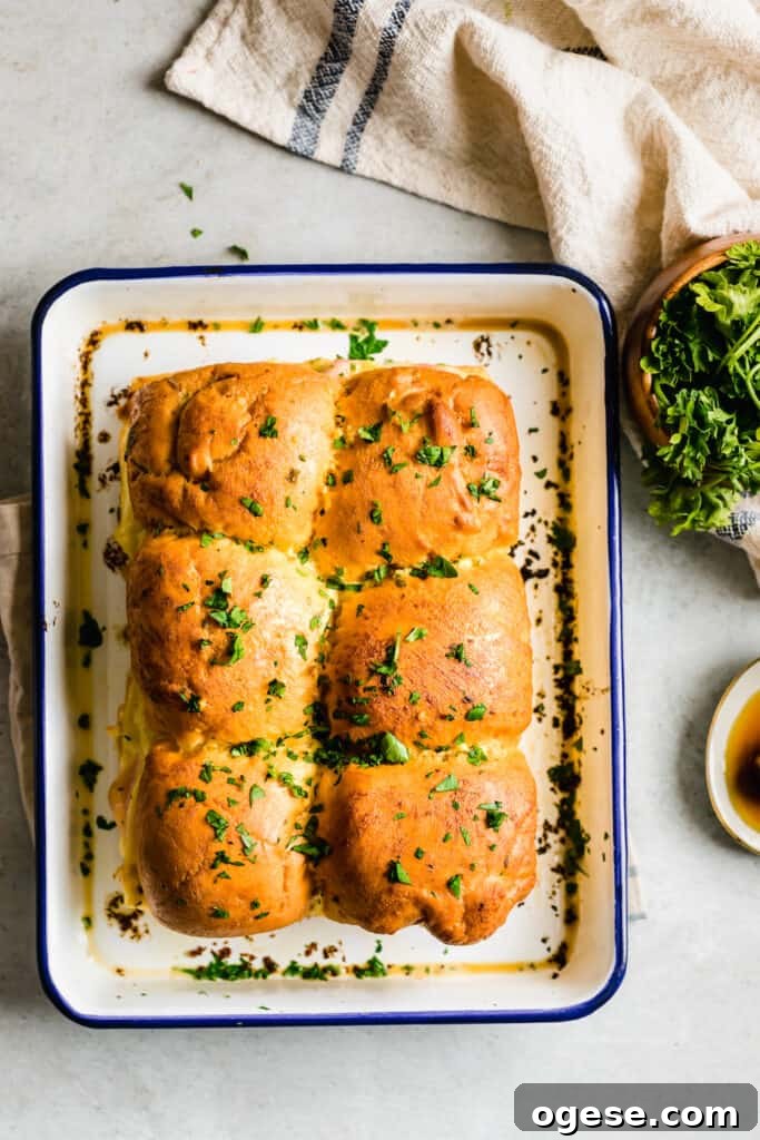Savory Ham and Swiss Sliders with Honey-Dijon Glaze 9 Six Ham and Cheese Sandwiches Topped with Butter and Parsley