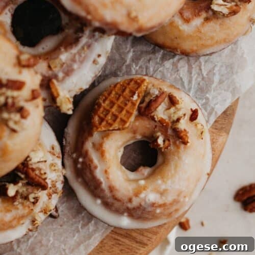 Glazed maple doughnuts on a wooden board