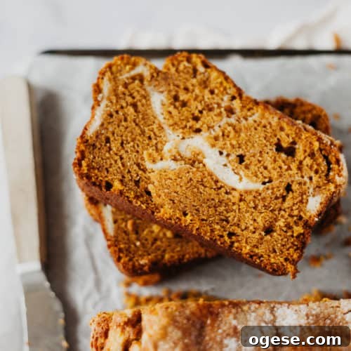 one slice of pumpkin bread on a tower of other slies