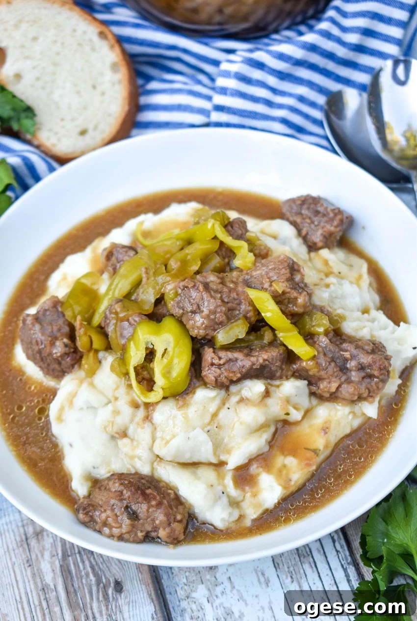 Mississippi Pot Roast Stew Recipe: Slow-Cooked Tender Beef 6 mississippi beef stew served over mashed potatoes in a white bowl