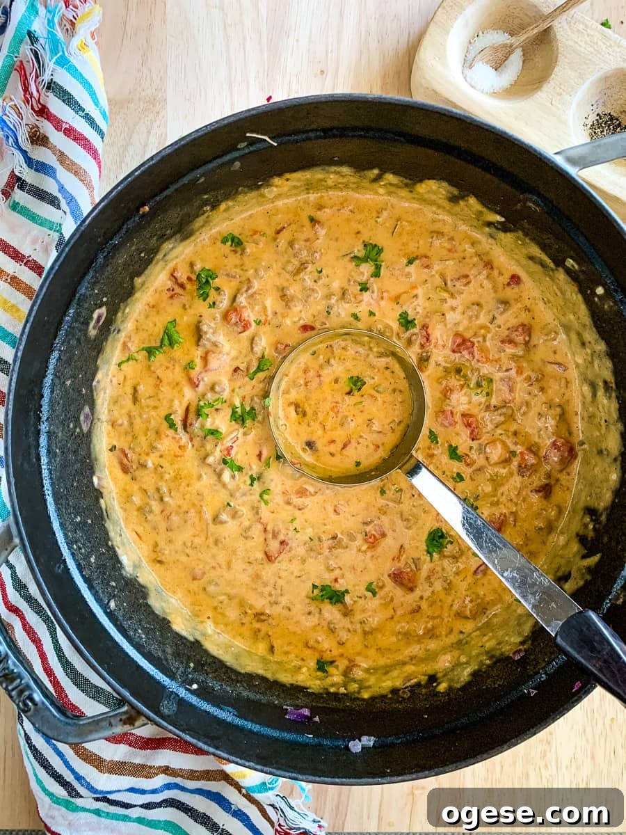 Ladle in a pot of keto cheeseburger soup.