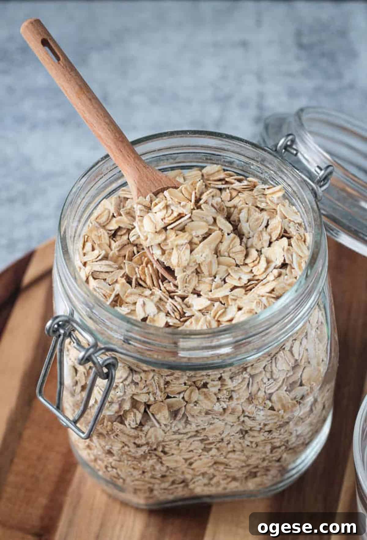 Creamy Oatmeal Recipes for Smooth, Nutritious Breakfasts 4 Raw rolled oats in an open glass jar with a wooden spoon.
