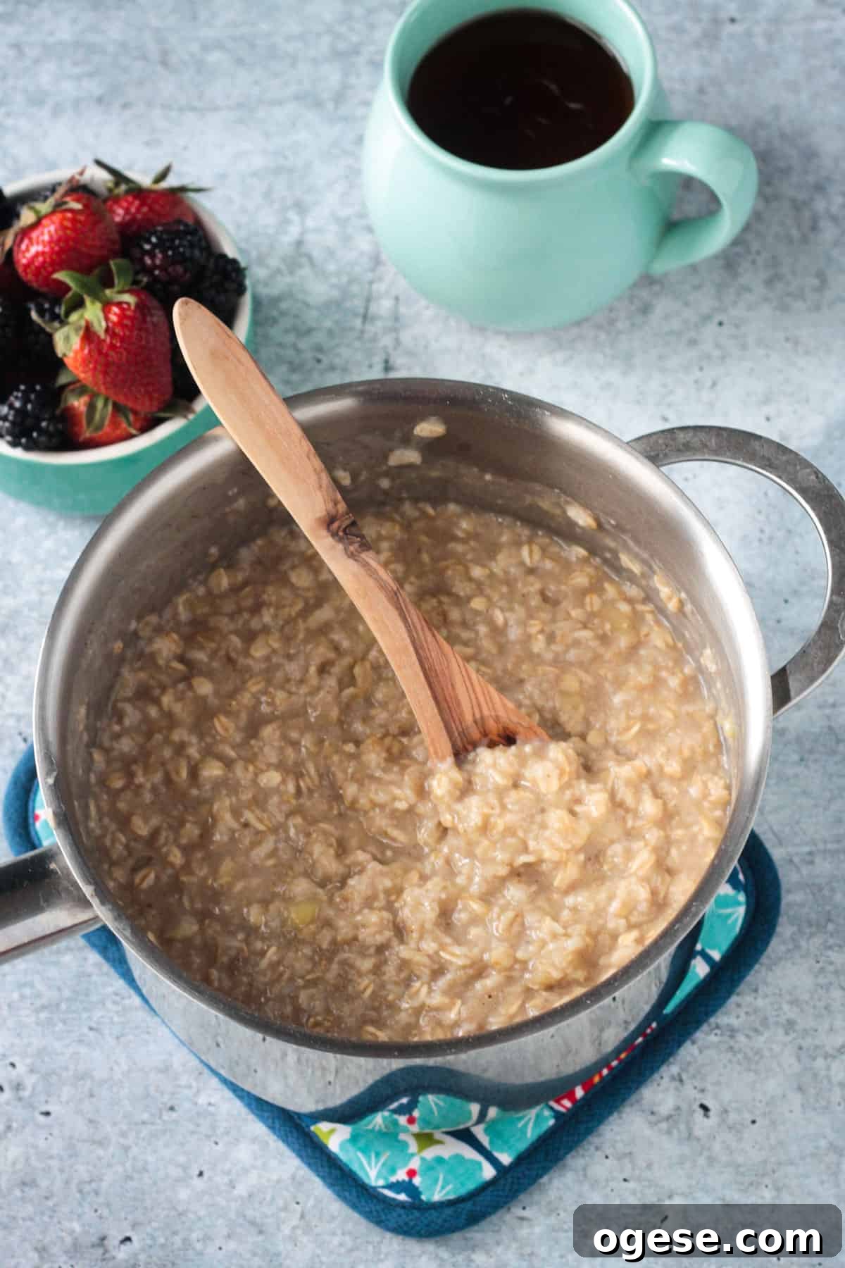Creamy Oatmeal Recipes for Smooth, Nutritious Breakfasts 6 A wooden spoon stirring a pot of creamy oatmeal.