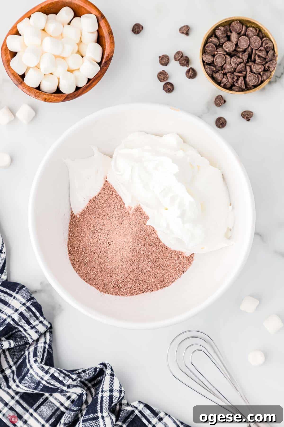 Hot Cocoa Dip Recipe for Dipping Cookies and Fruit 4 cocoa powder and whipped topping in a bowl with a whisk