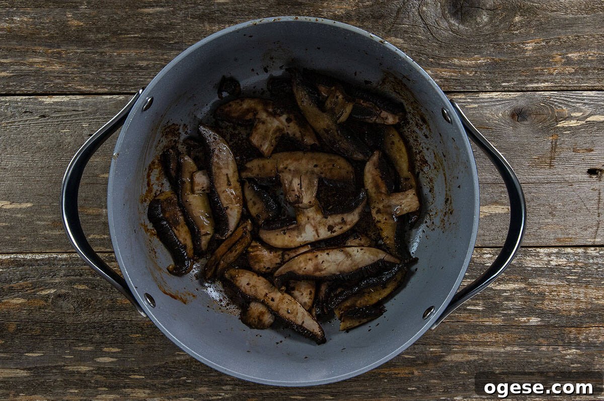Sliced portobella mushrooms in the Dutch oven.