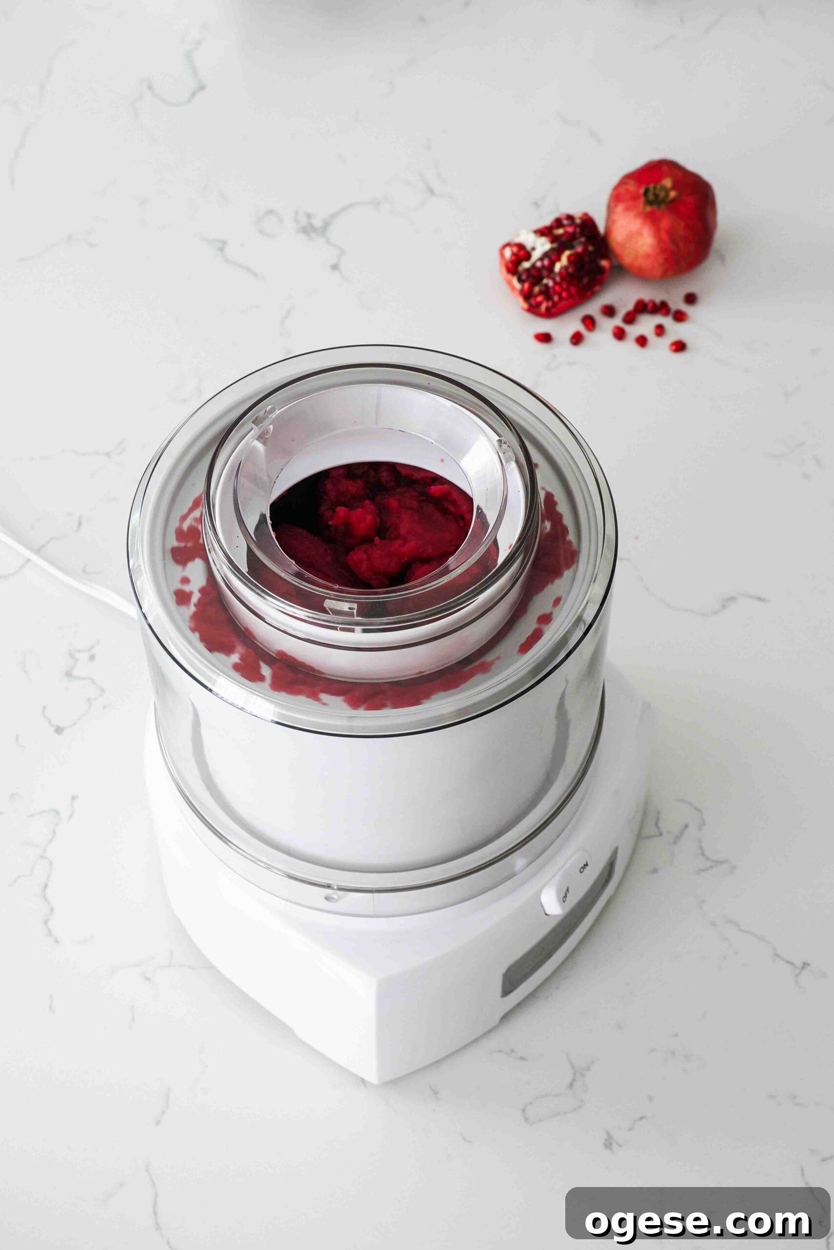 Frozen pomegranate sorbet in an ice cream maker.