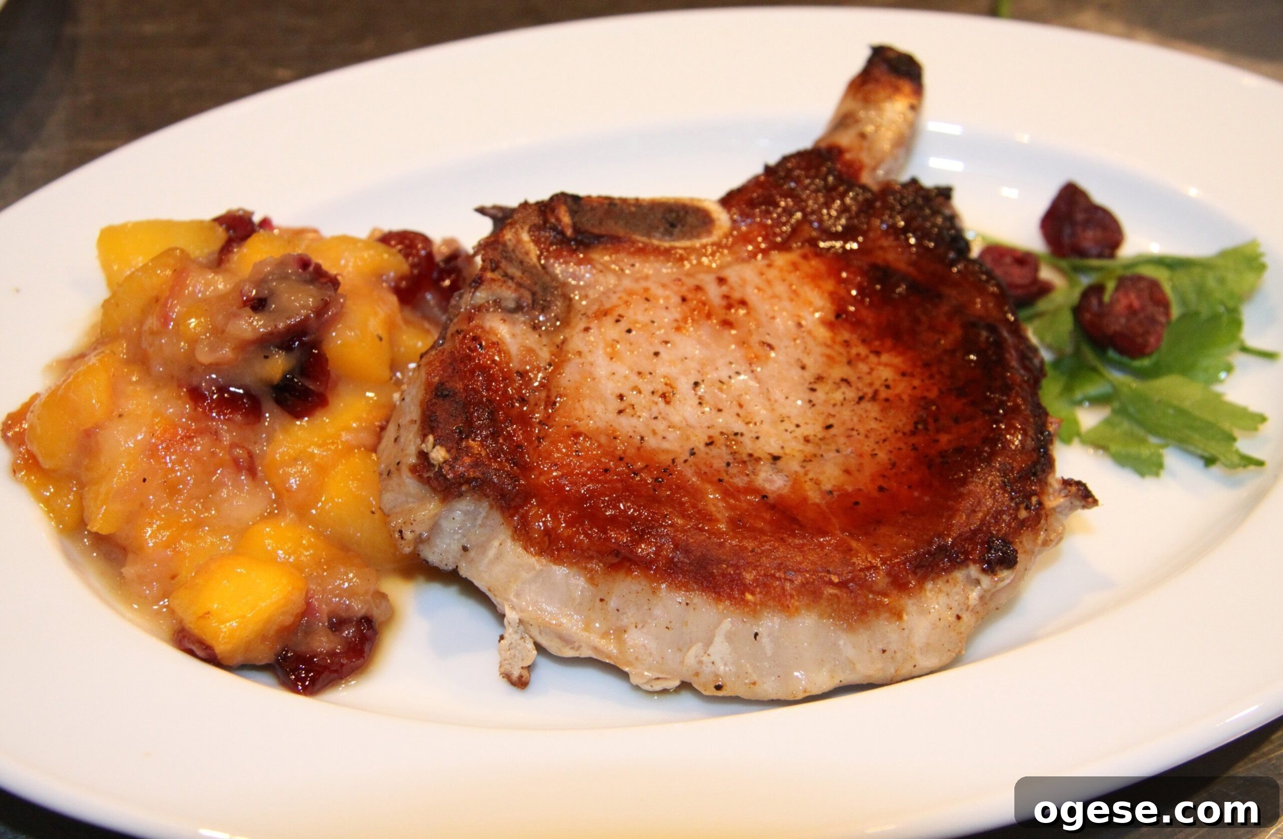Pan-Seared Pork Chops with Peach and Pear Pan Sauce 2 pork chops with peaches and pears sauce