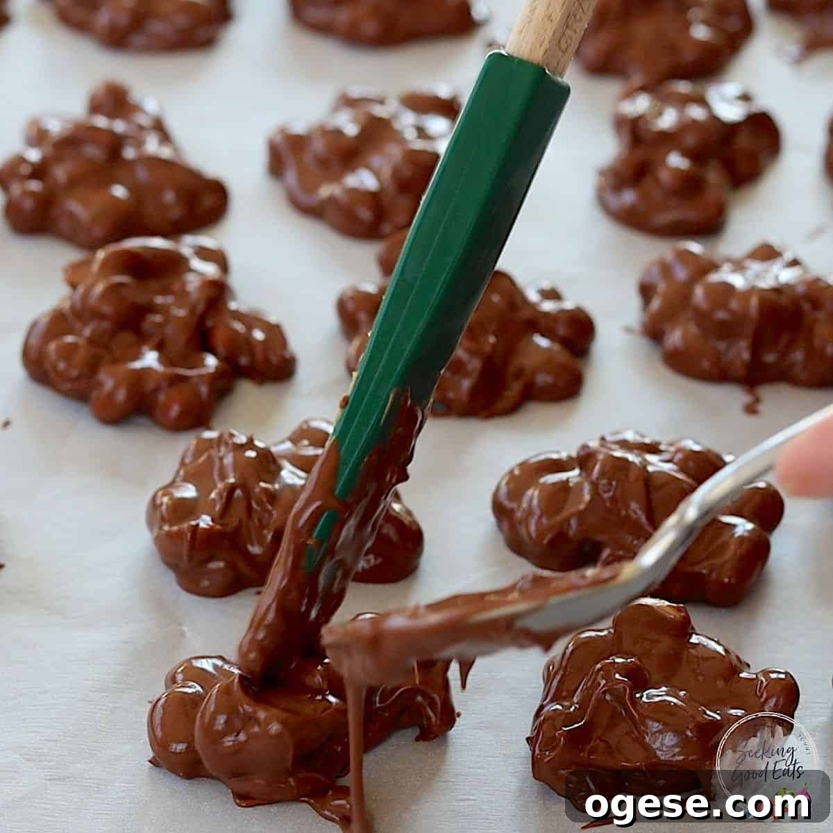 4-Ingredient Crockpot Peanut Clusters Recipe 6 Dropping the crock pot peanut clusters by the spoonful on a parchment lined baking sheet.