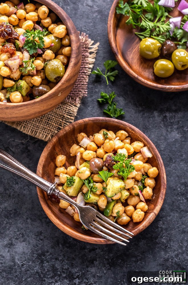 chickpea salad served in a 2 wooden plates and 1 wooden bowl