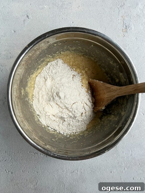 Adding flour to chocolate chip loaf batter.