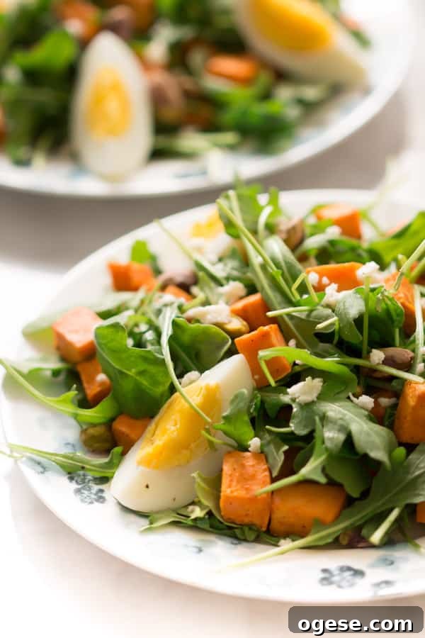 sweet-potato-arugula-salad - This Sweet Potato Arugula Salad is packed with pistachios, sweet potato, feta cheese and a delicious honey Dijon vinaigrette that pairs deliciously with arugula.