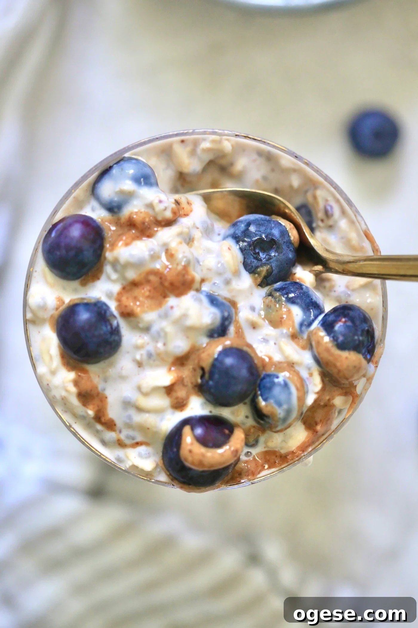 glass with blueberry oatmeal and spoon