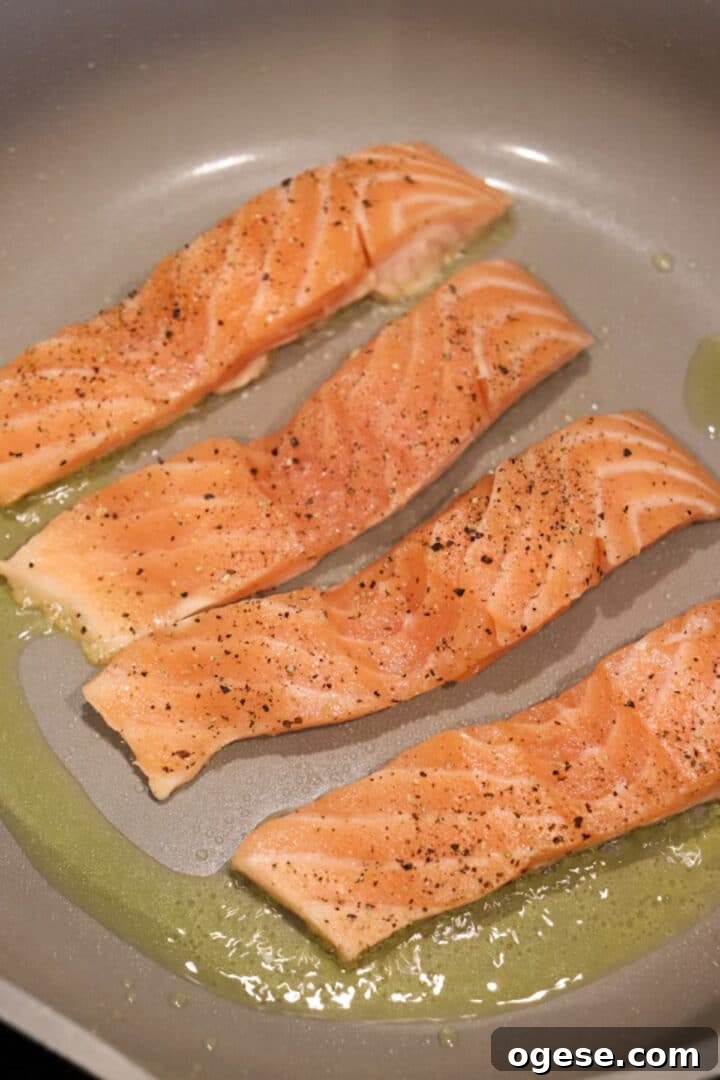 One-Pan Lemon Salmon and Orzo Recipe 6 Four salmon fillets in a non-stick skillet, uncooked side up