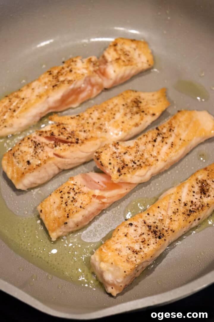 One-Pan Lemon Salmon and Orzo Recipe 7 Partially cooked salmon fillets in a non-stick skillet with olive oil